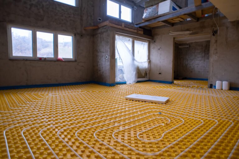 yellow underfloor heating installation with white pipes